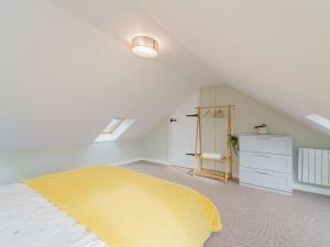 a attic bedroom with a bed and a dresser at 2 Bed in Aberystwyth 83552 in Llanilar