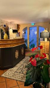 a lobby with a counter and a plant in a room at COLOMBA Hôtel Restaurant in Bonifacio