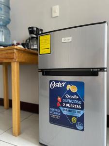 a refrigerator with a sticker on it in a kitchen at Habitacion privada Lamat I in San Pedro La Laguna