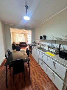 a kitchen with a table and a dining room at CASTELLARES LA PUEBLA APARTAMENT in Ayacucho