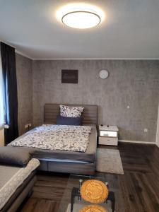 a bedroom with a bed and a couch at Ferienwohnung Rhein-Main II in Flörsheim am Main