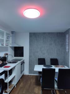 a kitchen with a table and chairs and a red light at Ferienwohnung Rhein-Main II in Flörsheim am Main