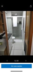 a bathroom with a shower and a toilet and a sink at Apt Completo no West Flat in Mossoró