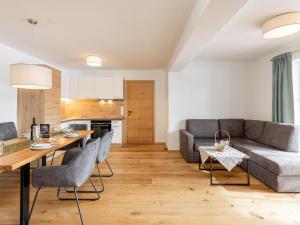 a living room with a couch and a table at Lärchenhof Top 202 in Mauterndorf