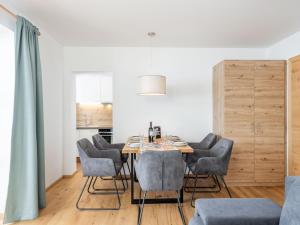 a dining room with a table and chairs at Lärchenhof Top 203 in Mauterndorf