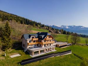 an aerial view of a house on a hill at Lärchenhof Top 303 in Mauterndorf