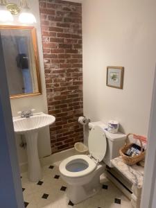 a bathroom with a white toilet and a sink at High Tide Inn on the Ocean, Motel and Cottages in Camden
