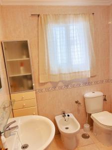 a bathroom with a white sink and a toilet at Habitación compartido Huelva centro in Huelva
