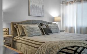 a bedroom with a large bed with pillows on it at NEW- Lovely 2-Bdr2Bath Gatlinburg Condo with resort indoor pool hot tub Wi-fi, great location in Gatlinburg +41 photos