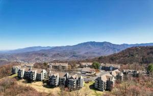 arial view of a residential neighborhood with mountains in the background at NEW- Lovely 2-Bdr2Bath Gatlinburg Condo with resort indoor pool hot tub Wi-fi, great location in Gatlinburg