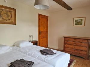una camera con letto bianco e cassettiera in legno di Gite du Bois a Guignicourt-sur-Vence