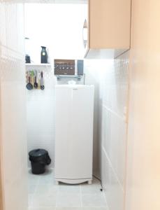 a kitchen with a white refrigerator in a room at Apartamento Vista Mar in Rio de Janeiro