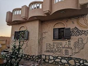 a building with a painting on the side of it at غزاله كامب in Siwa
