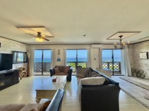 a living room with a couch and a table at Araha Resort Arapana in Chatan +118 photos