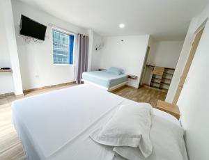 Ένα ή περισσότερα κρεβάτια σε δωμάτιο στο HOTEL EBENEZER