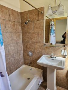 a bathroom with a sink and a bath tub at Travel Inn Motel in Canon City