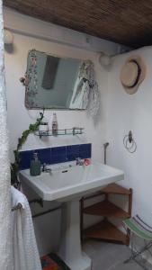 a bathroom with a white sink and a mirror at Beach Wave Melides Villa in Melides +48 photos