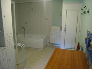 Habitación con baño con bañera y mesa. en Gîte Repaix, 5 pièces, 8 personnes - FR-1-584-45 