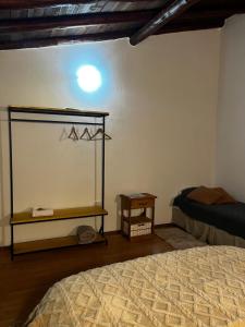 a bedroom with a bed and a table and a shelf at Trono de Nubes in Trevelin
