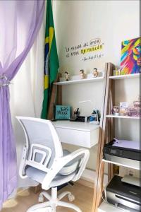uma cadeira branca numa sala com uma prateleira em Centro da Paulista: Sinta-se em casa!/wifi/TV em São Paulo