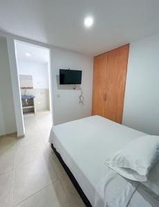 Ένα ή περισσότερα κρεβάτια σε δωμάτιο στο HOTEL EBENEZER