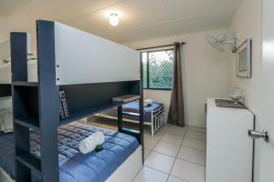 a small room with a bunk bed and a kitchen at A Lure - A 2-minute walk to the pristine beach! in Agnes Water