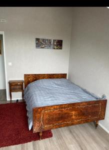 a bedroom with a wooden bed in a room at Chambre privée in Angers