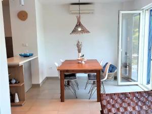 a dining room with a wooden table and chairs at Apartments by the sea Sobra, Mljet - 22329 in Babino Polje