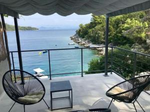 a balcony with chairs and a view of the water at Apartments by the sea Sobra, Mljet - 22329 in Babino Polje