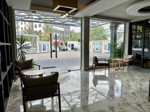un vestíbulo con sillas y mesas en un edificio en Serenity Suite With free Wi-Fi and Swimming pool en Dar es Salaam