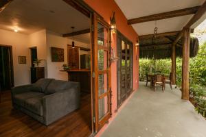 a living room with a couch and a table at Pousada Colmeia - Praia de Santo André, Bahia in Santo André
