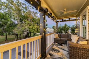 an outdoor patio with a couch and chairs on a porch at Villas of Ybor in Tampa