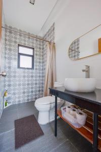 a bathroom with a sink and a toilet at ISLA VILLA 2 Luxury Pool Villa near beach with karaoke video games barbecue in Maribago