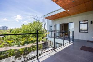 a balcony with a view of a building at ISLA VILLA 2 Luxury Pool Villa near beach with karaoke video games barbecue in Maribago