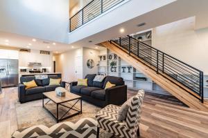 a living room with two couches and a staircase at Villas of Ybor in Tampa