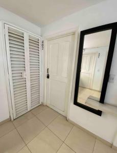 a mirror on a wall in a room with a door at Apartamentos Sur de Cali cerca a Unicentro - 402 in Cali