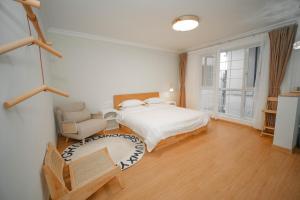 a bedroom with a bed and a chair at Leye Inn in Yangshuo
