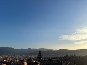 a view of a city with mountains in the background at Hotel vintage Home in Bhaktapur