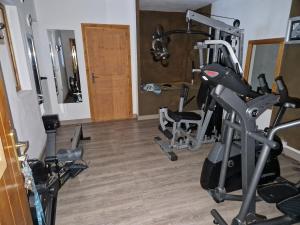 a gym with several treadmills and exercise bikes at Apartment on the slopes in the big ski area Grandes Rousses in Oz