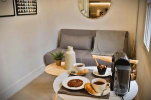 a coffee table with two cups of coffee and pastries at Luminoso Studio en Santiago Centro HOM in Santiago