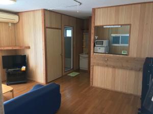 a living room with a toilet and a television at Marine Lodge Umigoya - Vacation STAY 23086v in Zamami