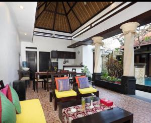 a living room with furniture and a dining area at Villa Cantik Tresna in Seminyak