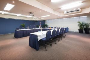 a conference room with a long table and chairs at Canberra Parklands Central Apartment Hotel Official in Canberra