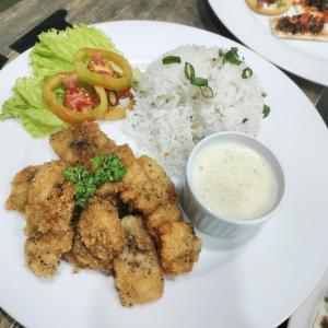 een bord met rijst en groenten en een saus bij Batad Pension and Restaurant in Banaue