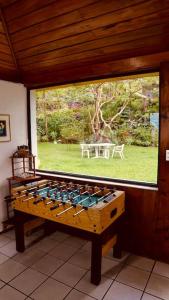 a large window in a room with a table in the yard at Inlaquesh Villa Atitlán in Cerro de Oro