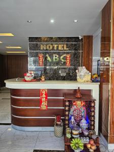 a hotel lobby with a hotel sign on the wall at ABC HOTEL BÌNH TÂN in Ho Chi Minh City