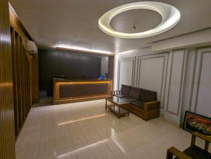 a room with a couch and a stage in a building at Hotel Hoque Tower International in Chittagong