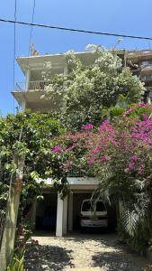 a white van parked in front of a building with flowers at Old Town Hotel in Kandy