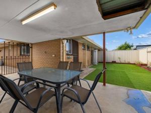 a patio with a table and chairs in a yard at Nook on Nixon in Shepparton