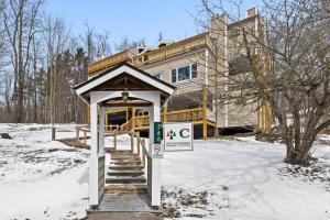 a sign in front of a building in the snow at Stowe Ski Chalet - 3BR with In Unit Sauna in Stowe